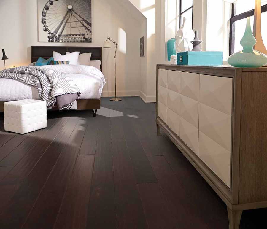 transitional bedroom with wood tones and dark hardwood